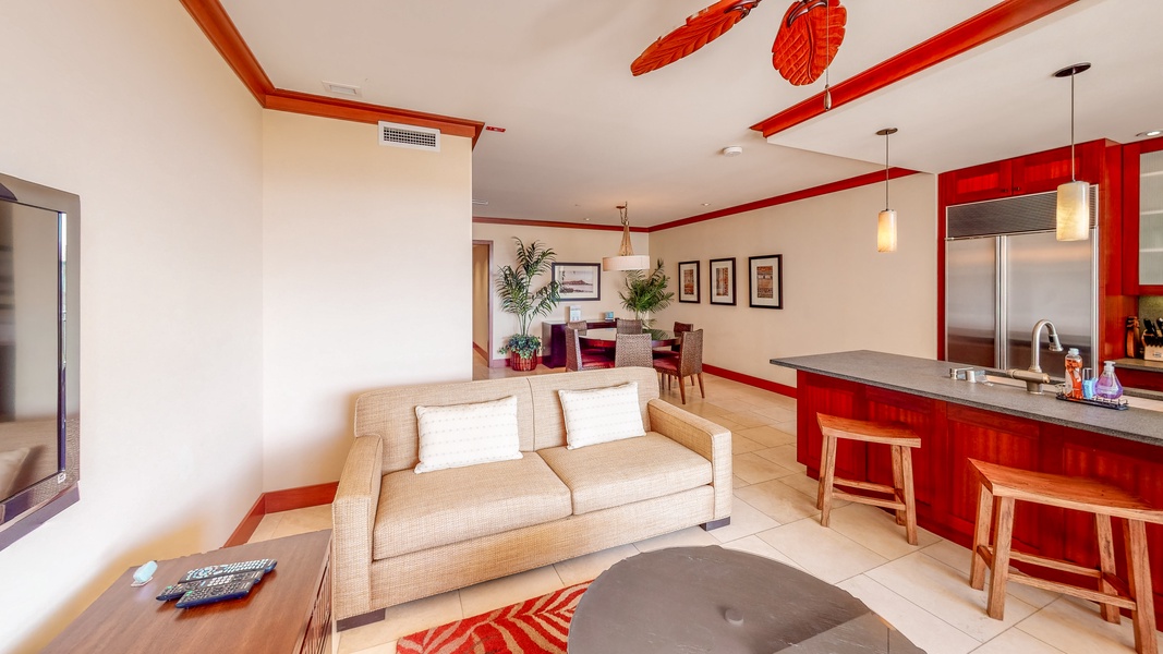The cozy living room features a comfortable sofa with a pullout bed for extra guests.