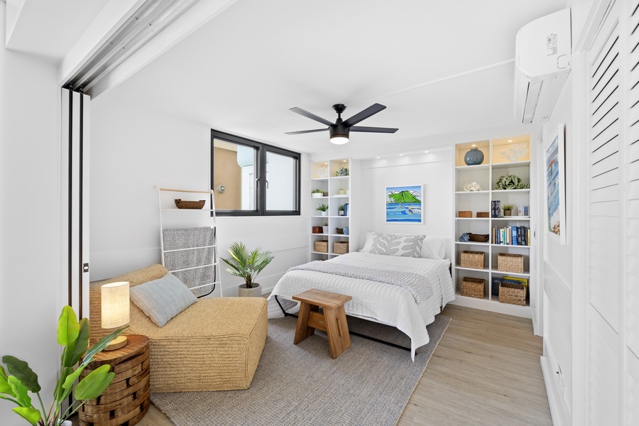 Unwind in this serene bedroom featuring a cozy bed, stylish built-in shelves, and soft, inviting colors.