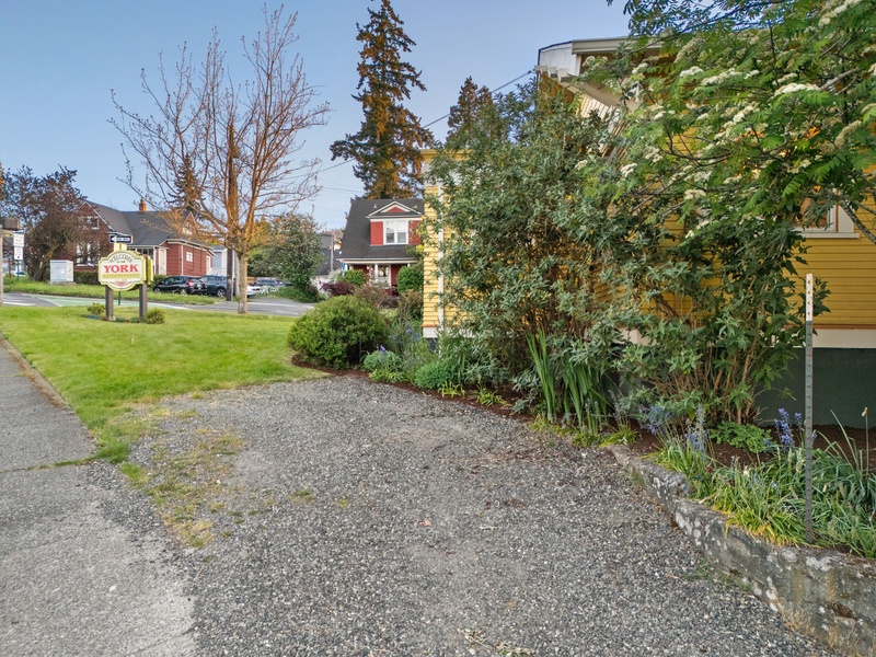 Park with ease beside landscaped greenery in this quiet residential setting.