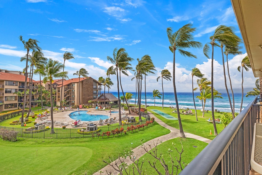 The lanai offers breathtaking views of the resort's pool area and the stunning ocean, perfect for enjoying the tropical scenery and vibrant atmosphere.