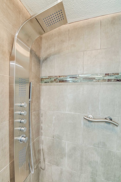 Indulge in spa-like luxury with a multi-function shower system—perfect for unwinding after beach or golf adventures.