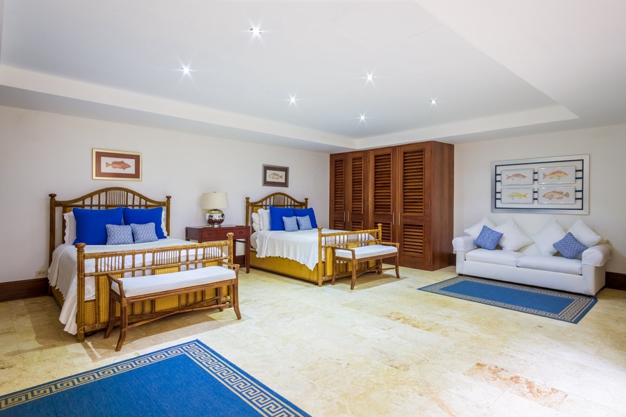 The guest bedroom offers two queen-sized beds.