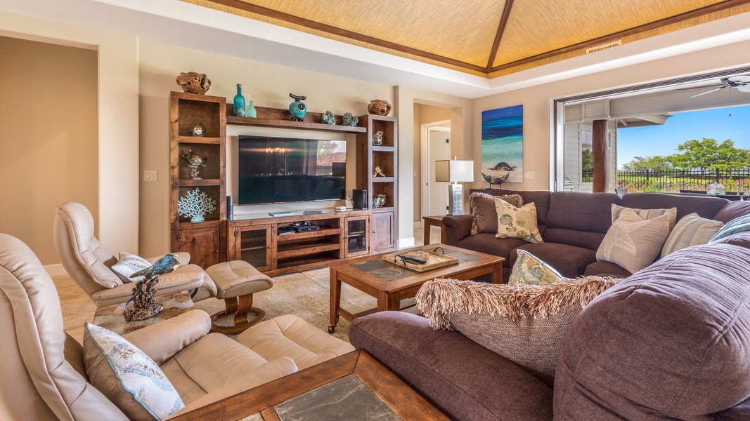Spacious living area with high-end lounge chairs, plush sofas, and large flat-screen TV.