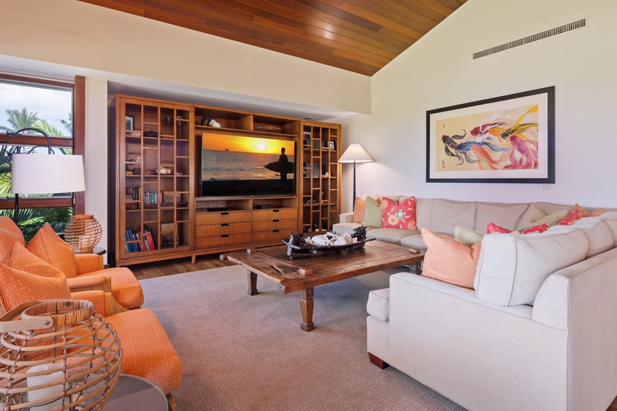 Unwind in your spacious living area with plush seating, entertainment center, and warm tropical touches throughout.