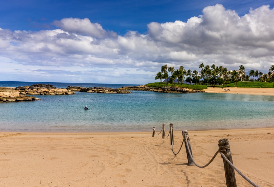 Take a stroll in the soft sand by the crystal blue lagoon.