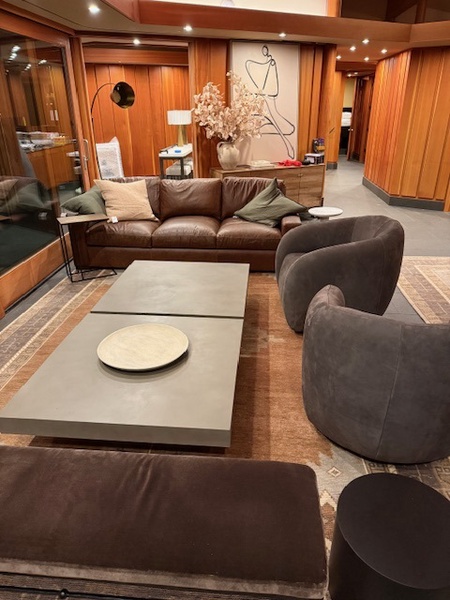 Warm and inviting living room with plush seating, a large coffee table, and elegant wooden accents for relaxation.