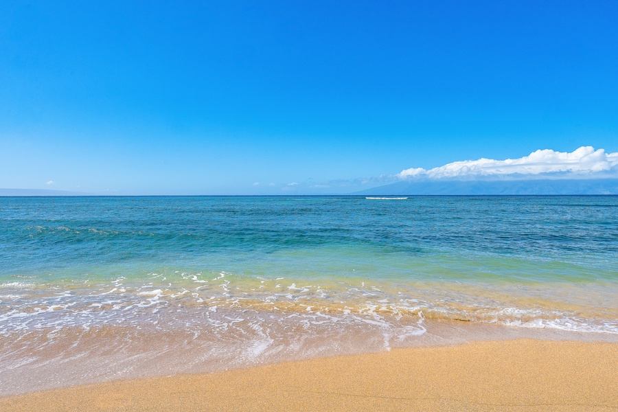Gentle waves meet soft sand just steps from Royal Kahana 610.