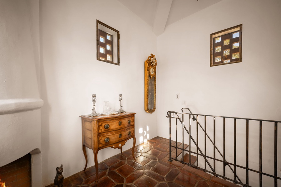 Climb the elegant stairway where antique charm meets modern comfort, with beautiful terracotta tiles beneath your feet.