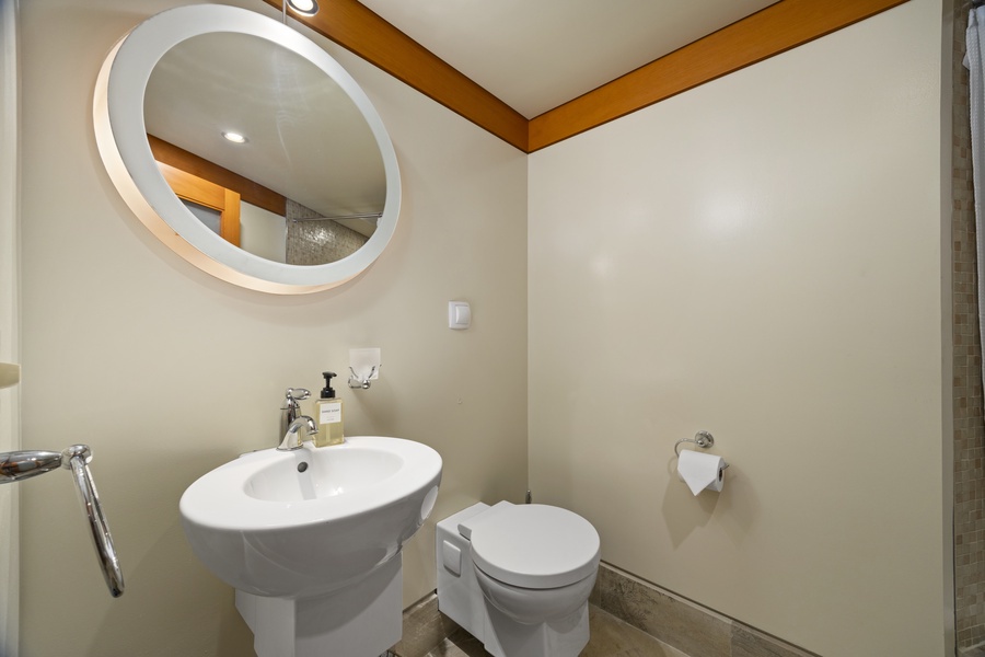 Your modern powder room features a stylish floating sink and backlit mirror, creating a sleek space for freshening up.