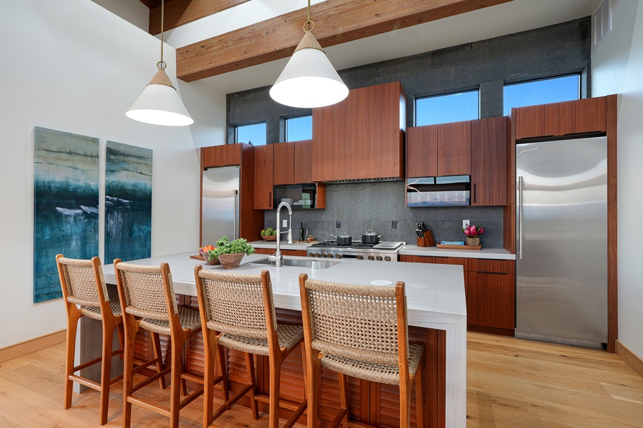 Gather around this inviting kitchen island, where warm wood tones and modern design create the perfect setting for socializing and culinary creativity.