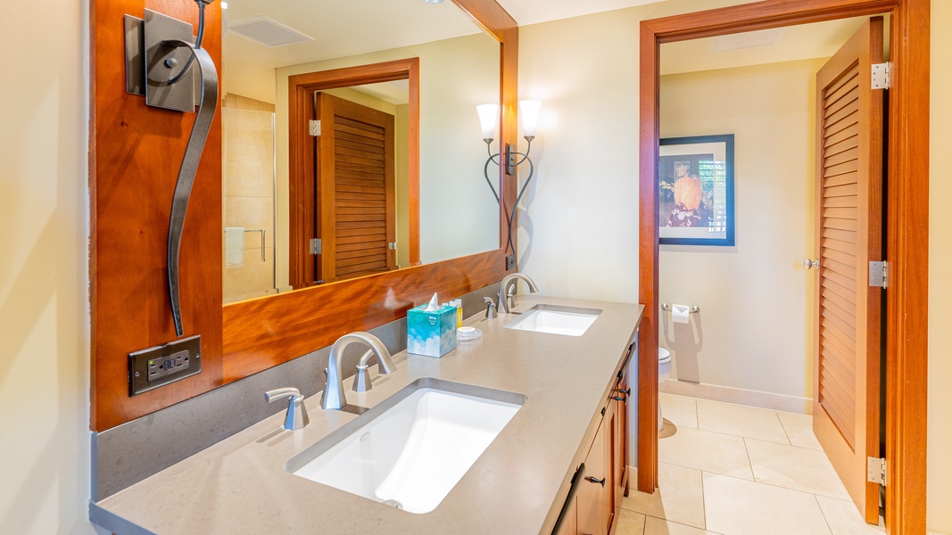 The primary guest bathroom with a double vanity and walk-in shower.