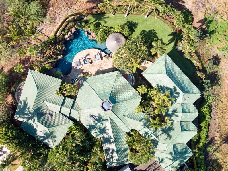 Aerial view of pod-style home offering scope and layout of this incredible architectural gem. Primary suite on left, great room in center, four bedroom suites on right.