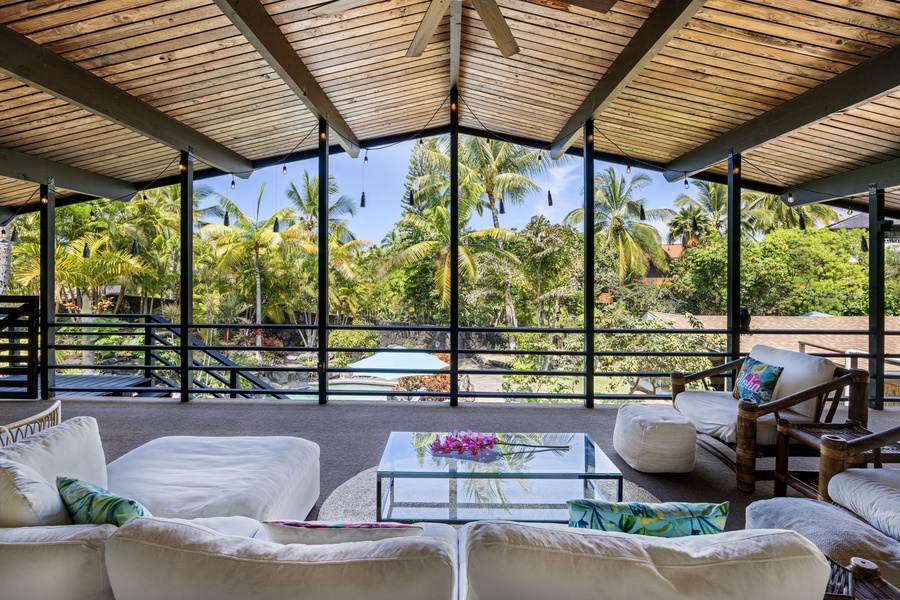 Your private tropical oasis awaits with plush seating and panoramic garden views where palm trees sway in the breeze.