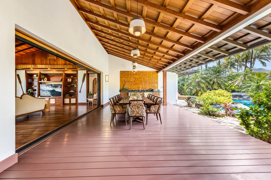 Expansive covered lanai perfect for open-air dining and lounging with lush tropical views.