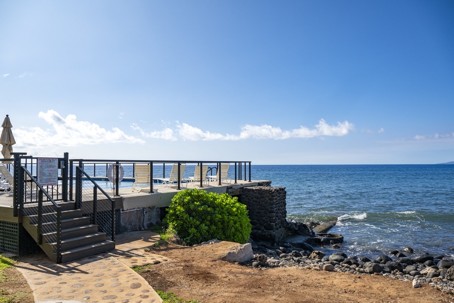 Stroll along the lava rock shoreline for sunset views right next to the pool entrance.