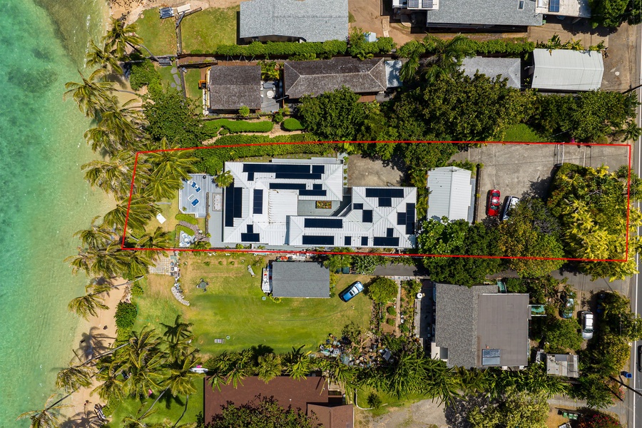 Bird’s-eye view of this private beachfront escape, nestled in tropical paradise.