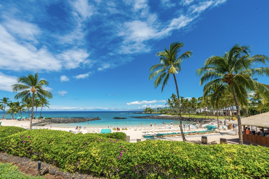 Soft sand and calm waters await by Fairmont Orchid Hotel, just steps from Pauoa Beach Club