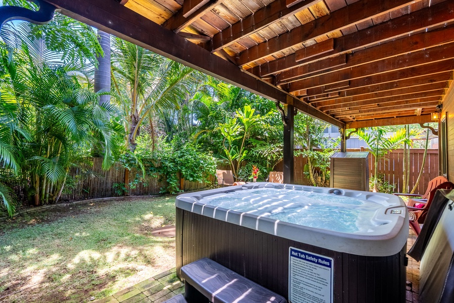 Relax in the lower-level private hot tub with views of the garden.