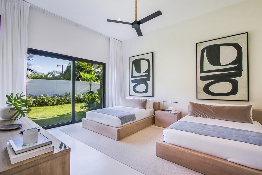 Guest bedroom with a view and two comfortable beds.