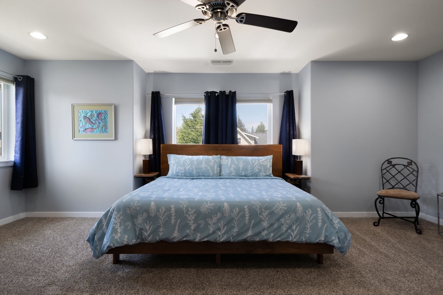 The bright primary bedroom offers comfortable furnishings, central A/C, and a peaceful atmosphere for restful nights.