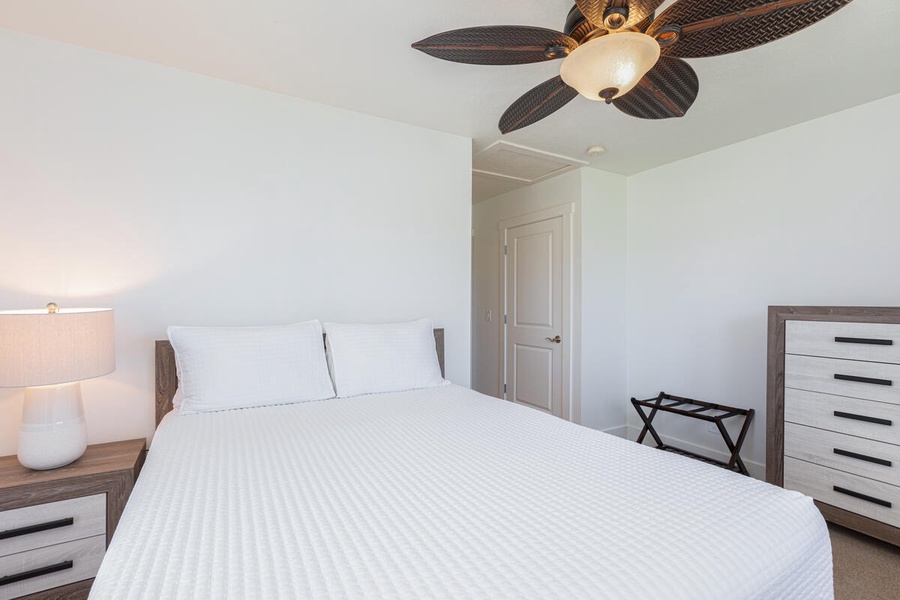Guest bedroom with a queen-size bed and warm ambiance.