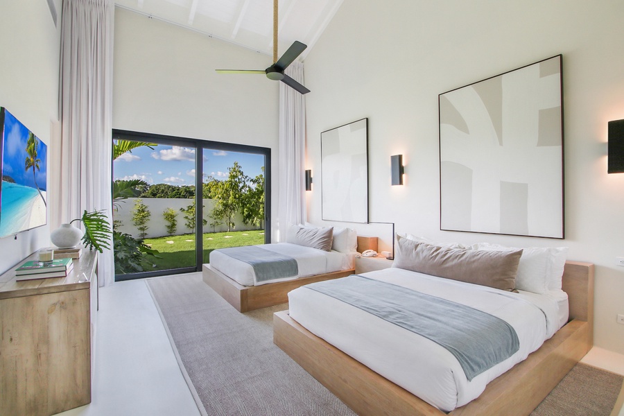 Clean and cozy guest bedroom with garden views and soft lighting.