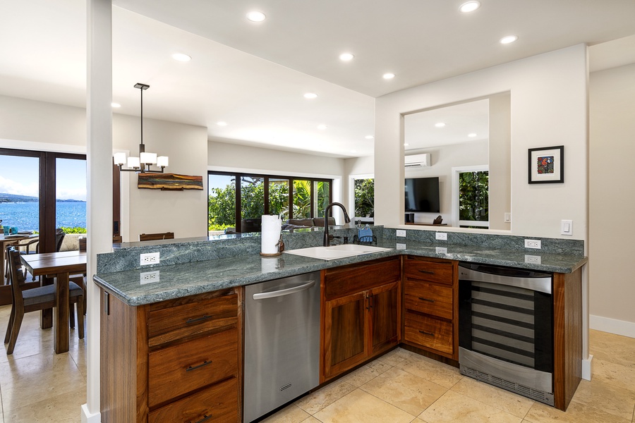 The large gourmet kitchen has been completely upgraded with granite countertops, Koa cabinets, and new stainless-steel appliances