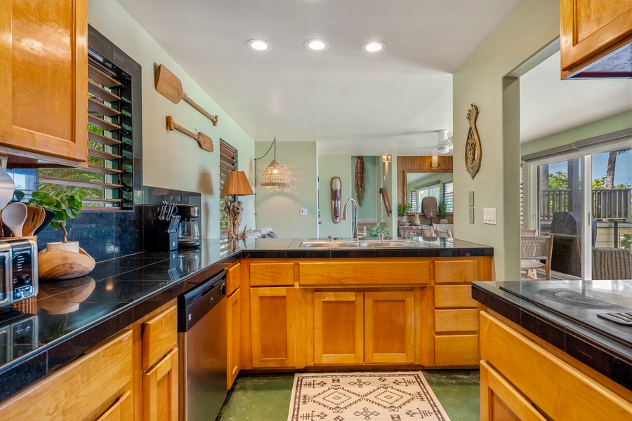 You'll love cooking in this warm kitchen featuring rich wood cabinets and spacious counter tops for casual dining.