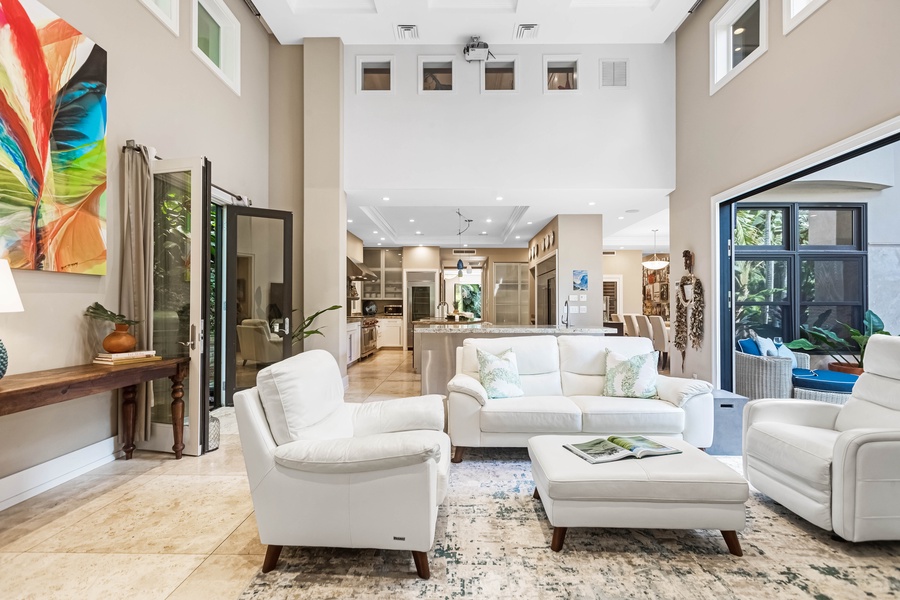 Open concept great room with comfortable seating and high ceilings.
