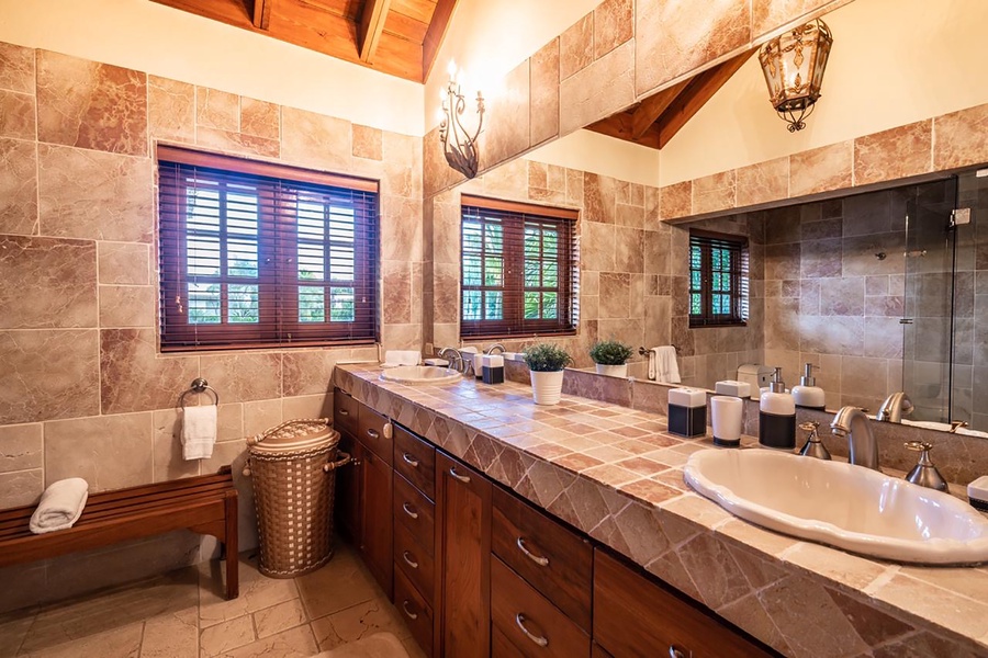 The primary ensuite bathroom also features a wooden window allowing natural light.
