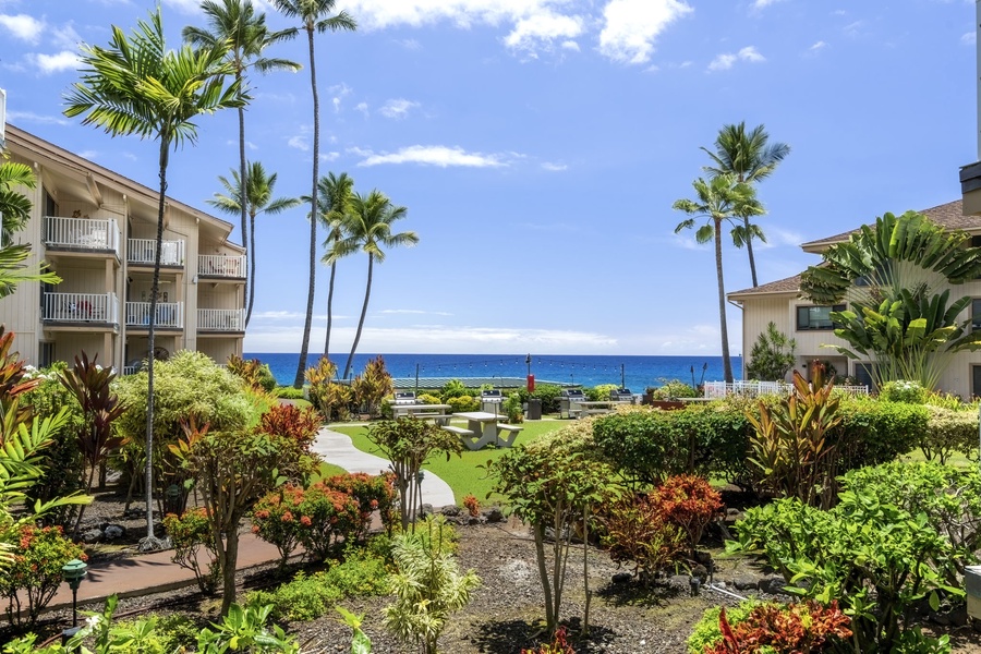 Manicured tropical gardens lead the way to your lanai—lush pathways meet Pacific horizons.