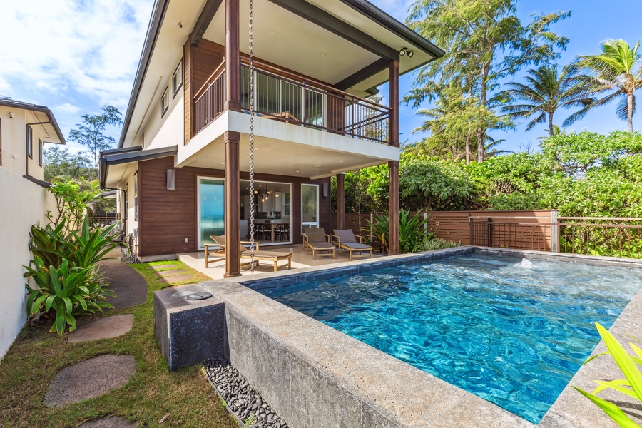 Relax by the infinity pool with breathtaking ocean views and lush greenery all around.