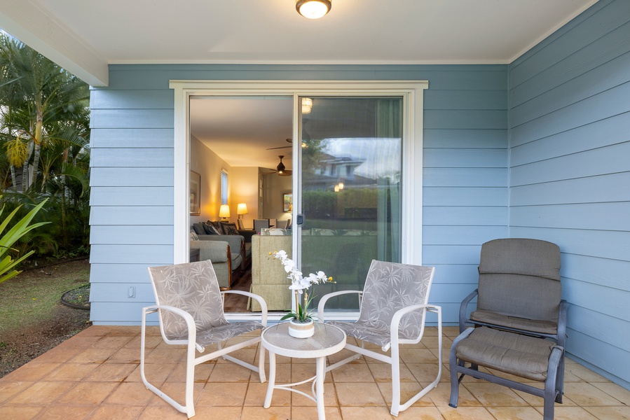 Relax on your private lanai with comfortable seating, perfect for morning coffee or evening conversations with tropical plants nearby.