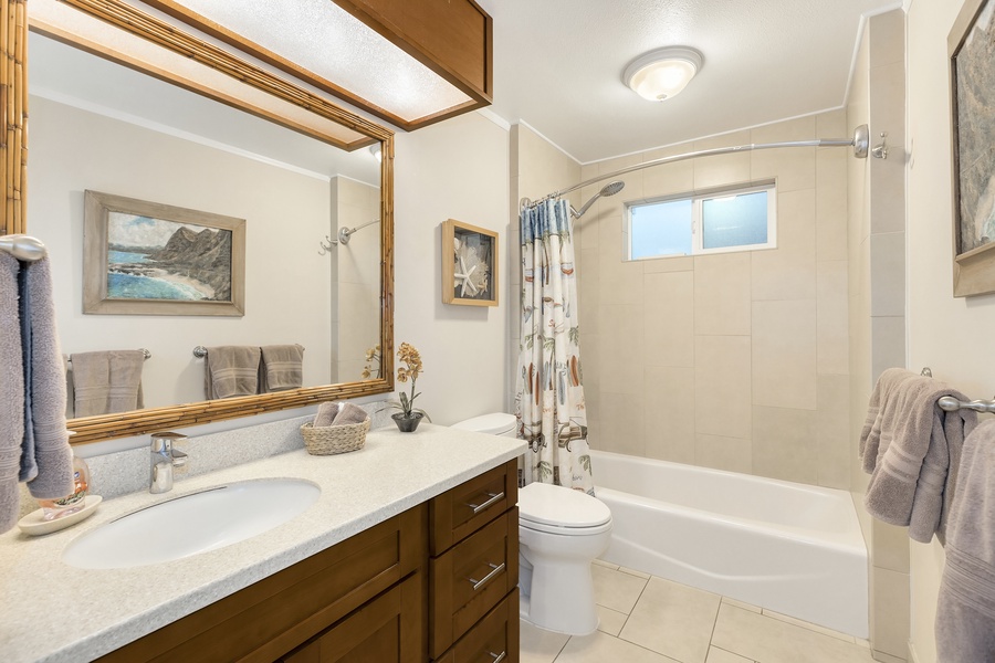 Shared bathroom with a shower/tub combo