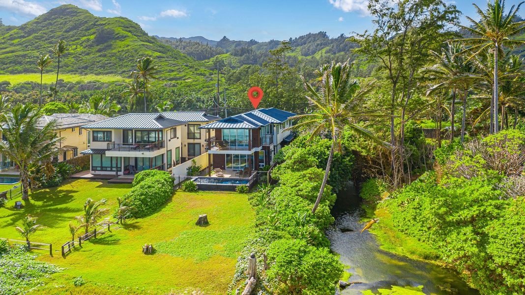 Aerial view of the expansive property surrounded by lush tropical foliage.