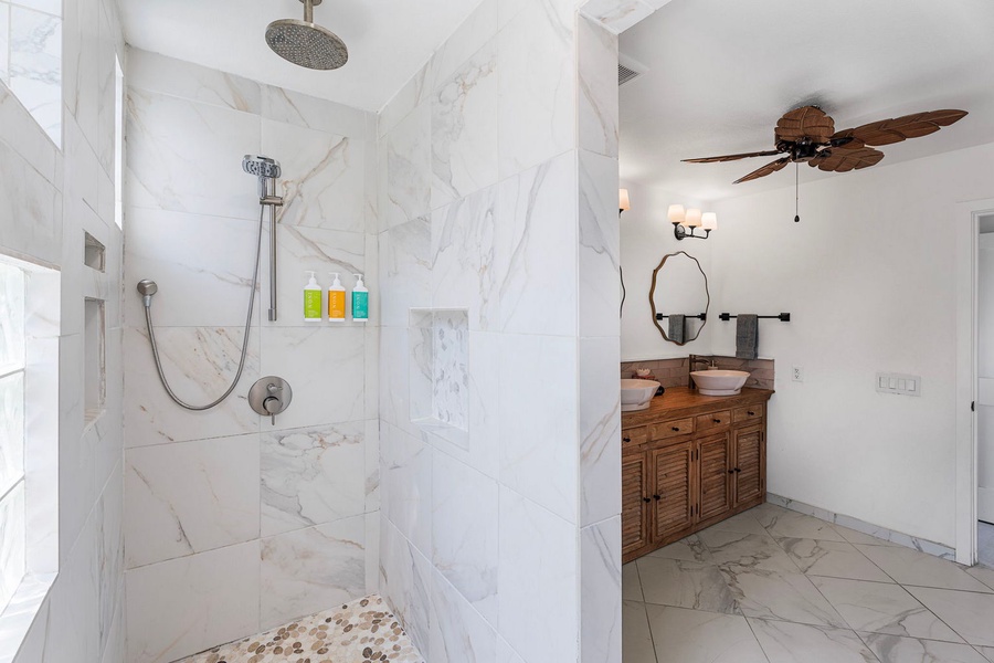 Step into the marble walk-in shower the primary suite was built around.