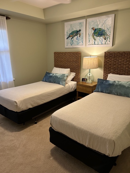 Kid-friendly guest room with two twin beds and playful touches — ideal for families.