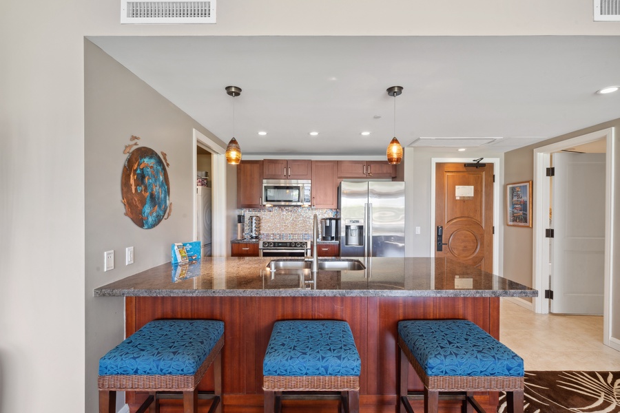 Start your day with fresh coffee at the kitchen island of Honua Kai Konea 204, complete with barstool seating.