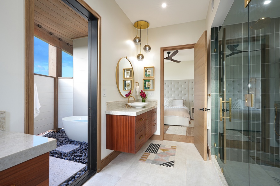 Step into this chic ensuite, where modern fixtures and warm wood tones are complemented by playful geometric mirrors, creating a space that's both inviting and stylish.
