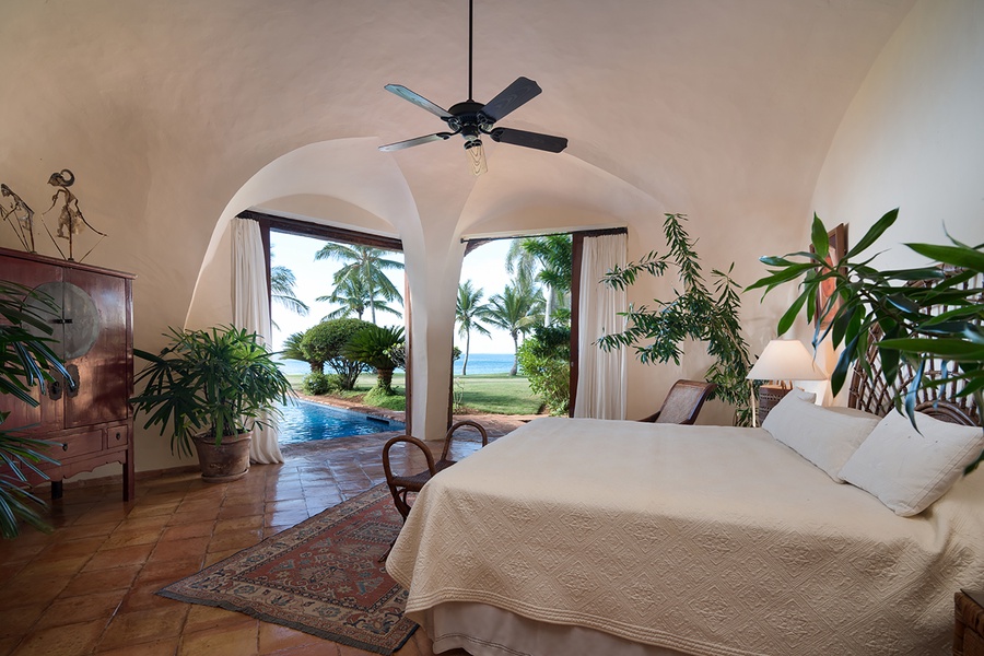 Primary bedroom featuring a private patio with oceanfront view.