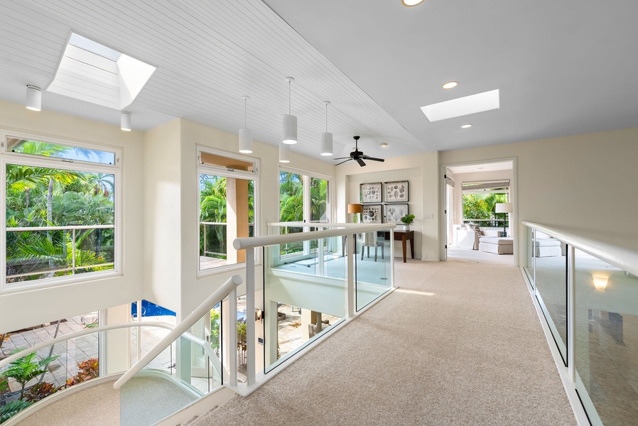 This bright upper level offers stunning garden views through floor-to-ceiling windows, creating your perfect retreat with modern style and tropical vistas.