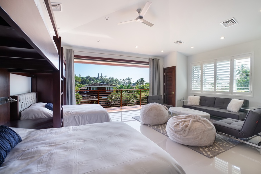 Third bedroom with balcony and cozy seating—blends comfort, light, and tropical views.