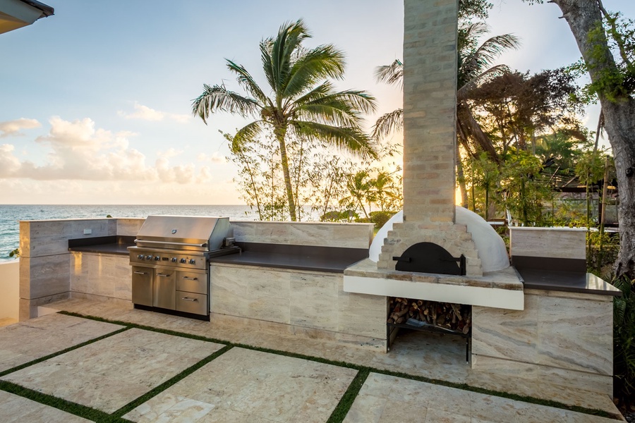Outdoor cooking at its finest with a modern grill and pizza oven.
