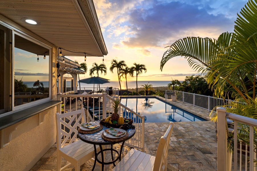Tropical paradise lanai with pool views where your morning coffee meets stunning sunsets over swaying palms.