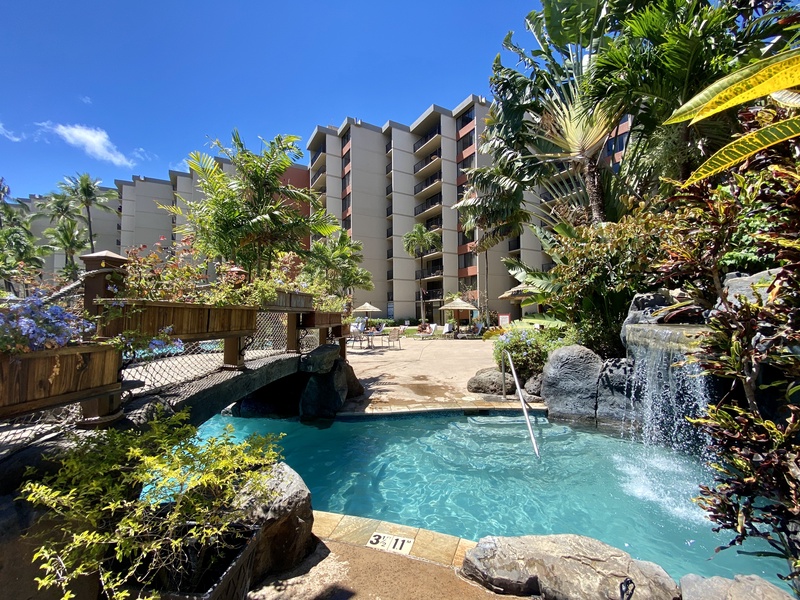 Find peace by the tranquil waterfalls surrounded by tropical beauty at Kaanapali Shores 213.