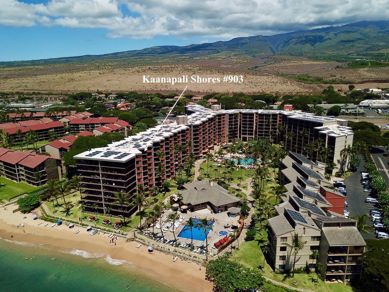 A stunning aerial view of Kaanapali Shores 903, offering a prime beachfront location with breathtaking views of the ocean and the resort's lush surroundings.