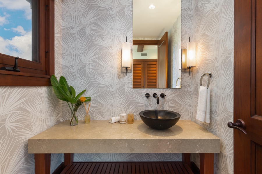Stylish powder room located on the upper level