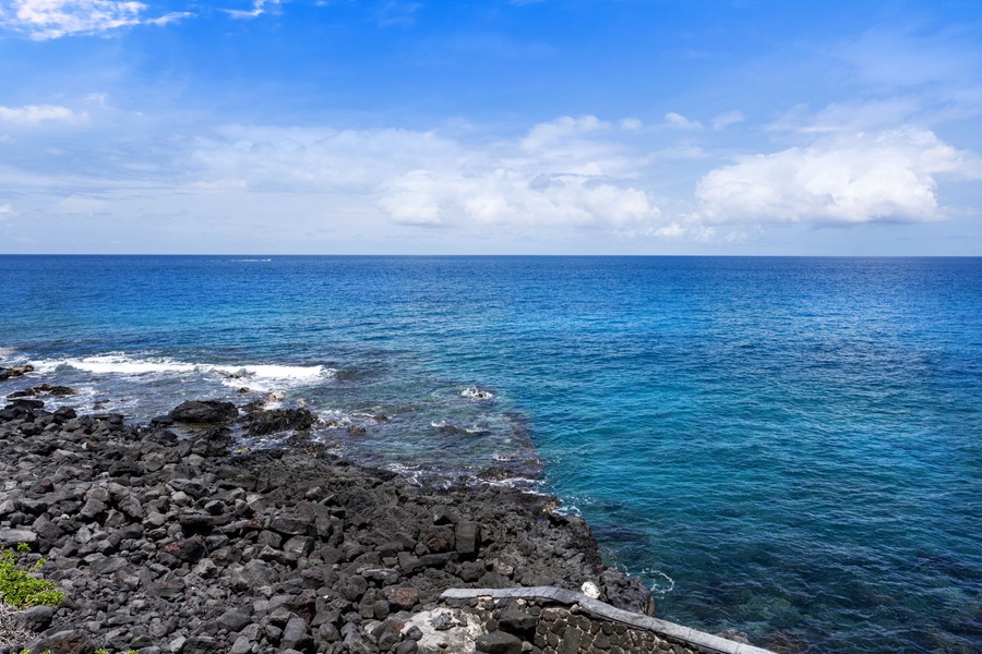 Rocky lava shoreline and vibrant blue waters just steps from your lanai—pure Big Island beauty.