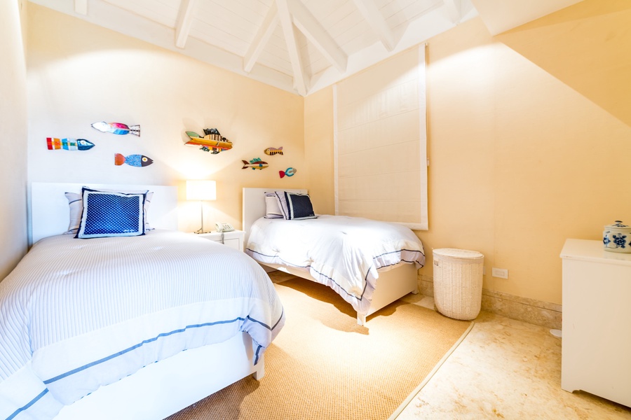 Guest bedroom decorated with playful fish-themed wall art, perfect for a relaxing and fun stay.