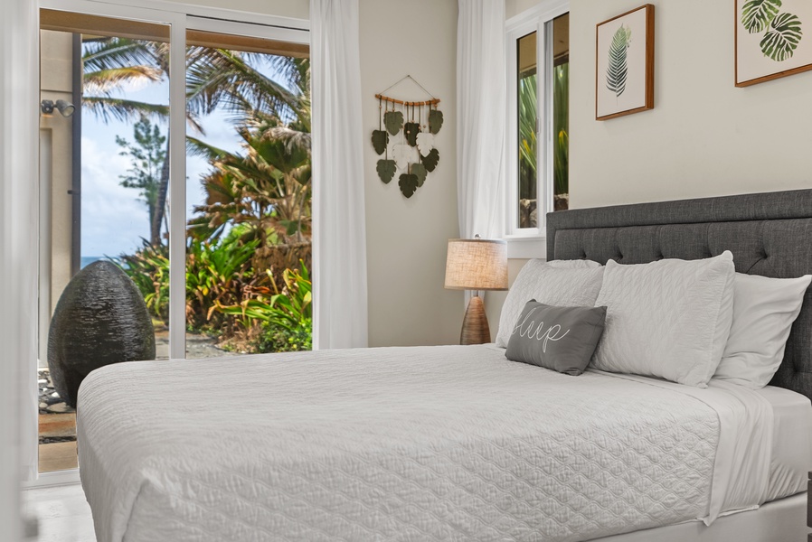 The lower-level bedroom with a queen bed and private lanai.